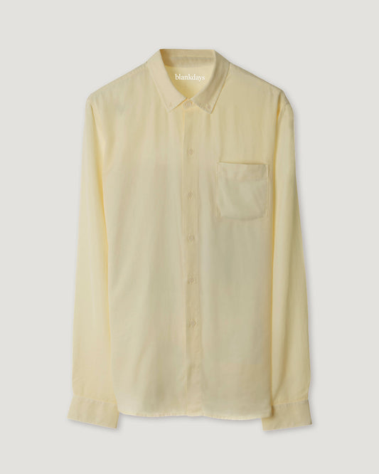 A sun bleached yellow, long-sleeved men's shirt with a button-down collar and a chest pocket.